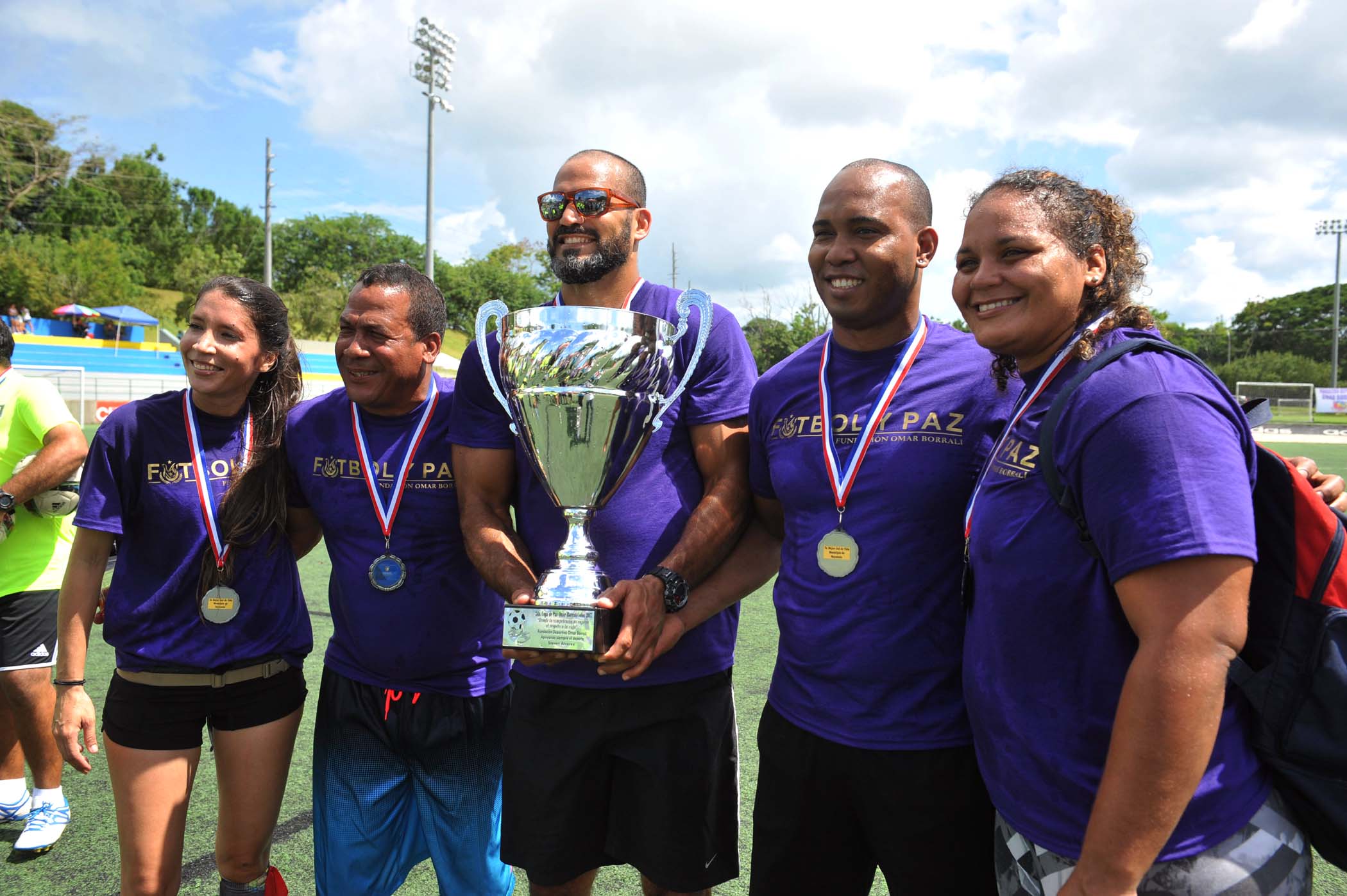 Equipo violeta con su trofeo y medallas